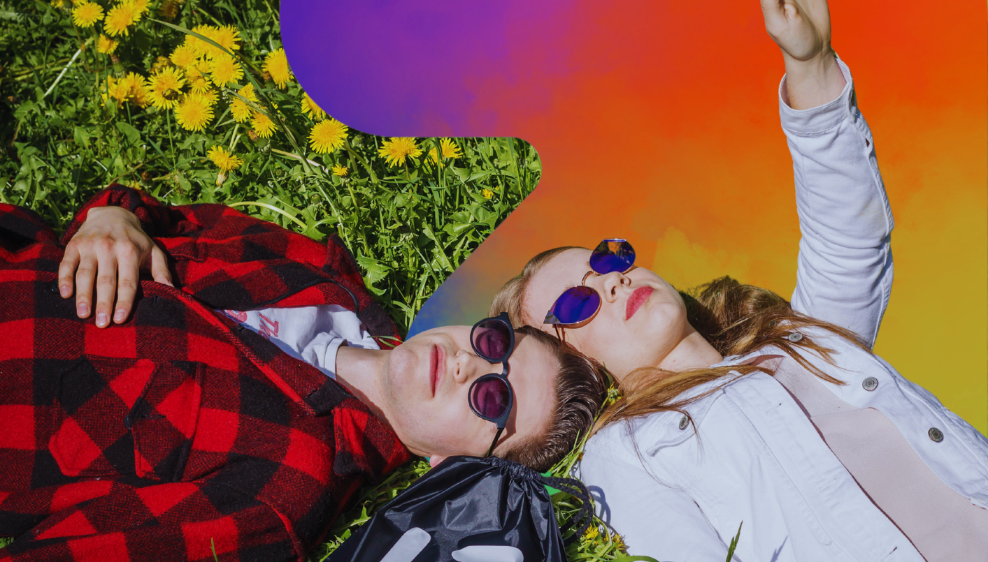 A photo depicting two young people lying on the grass among yellow flowers. Both are wearing sunglasses and looking upwards, while the woman raises her hand as if taking a photo or pointing at something in the sky. The image is partially complemented by a colorful, gradient background in shades of purple, red and orange