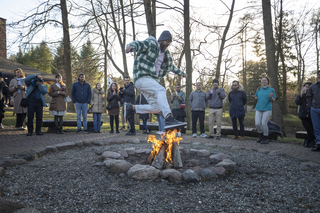A man jumping over the fire.