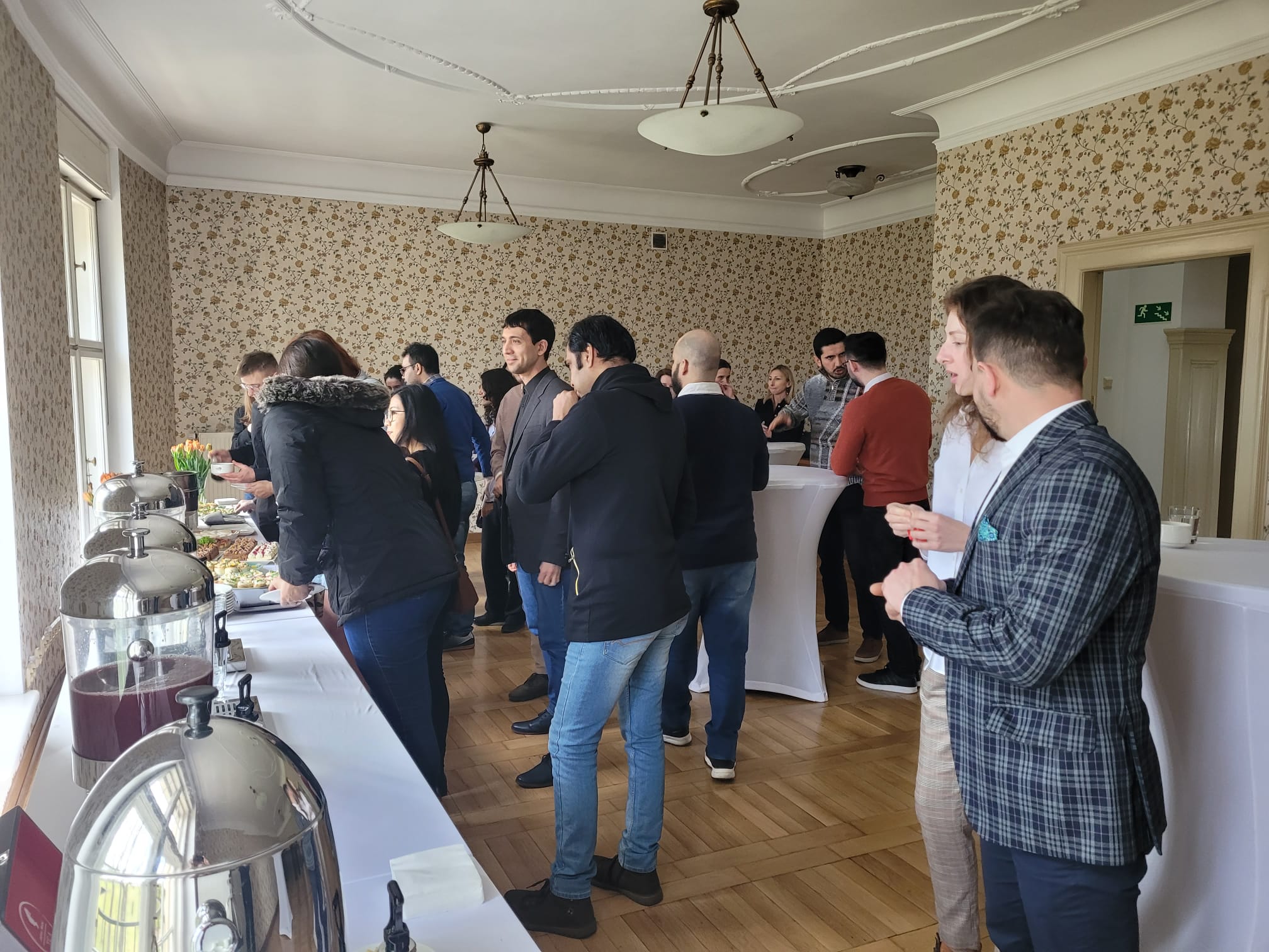 A group of people talking and eating.
