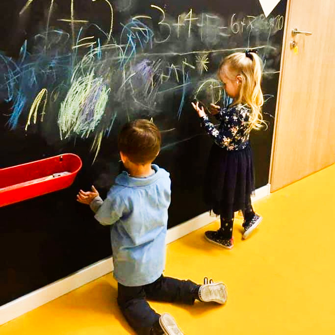 children writing on the blackboard