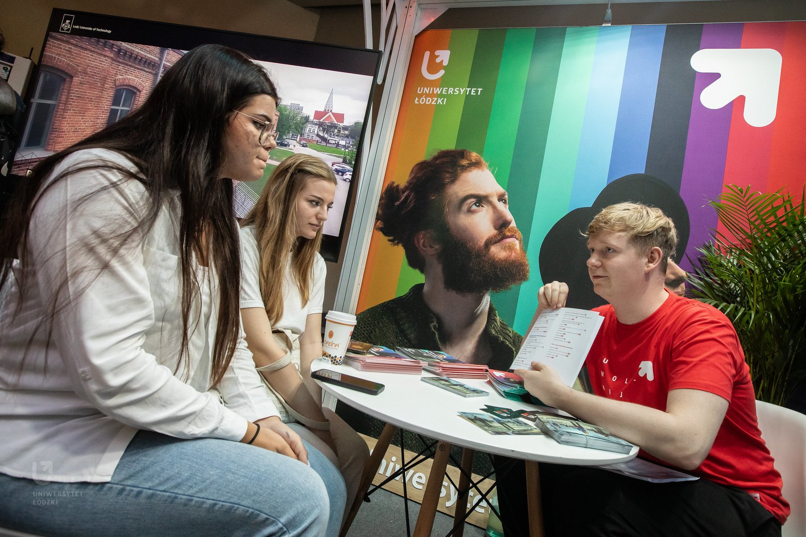A University of Lodz student showing the study offer to potential candidates.