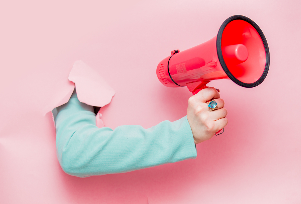 Female hand in classic blue jacket with megaphone ręka z megafonem