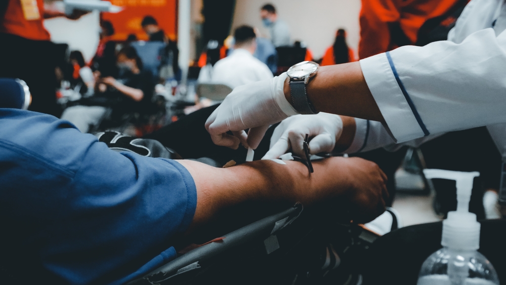 an arm of a person who is donating blood