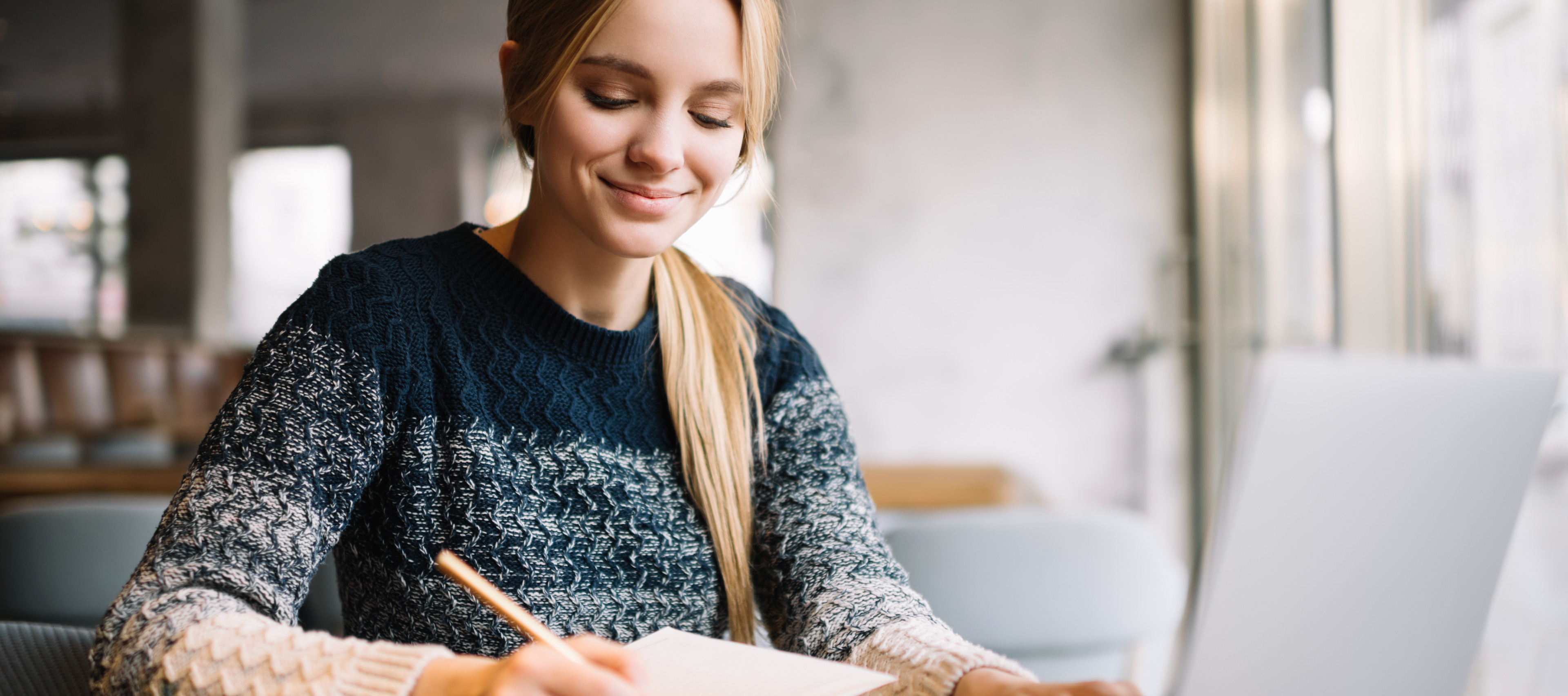 a decorative element: a girl taking notes in front of the computer
