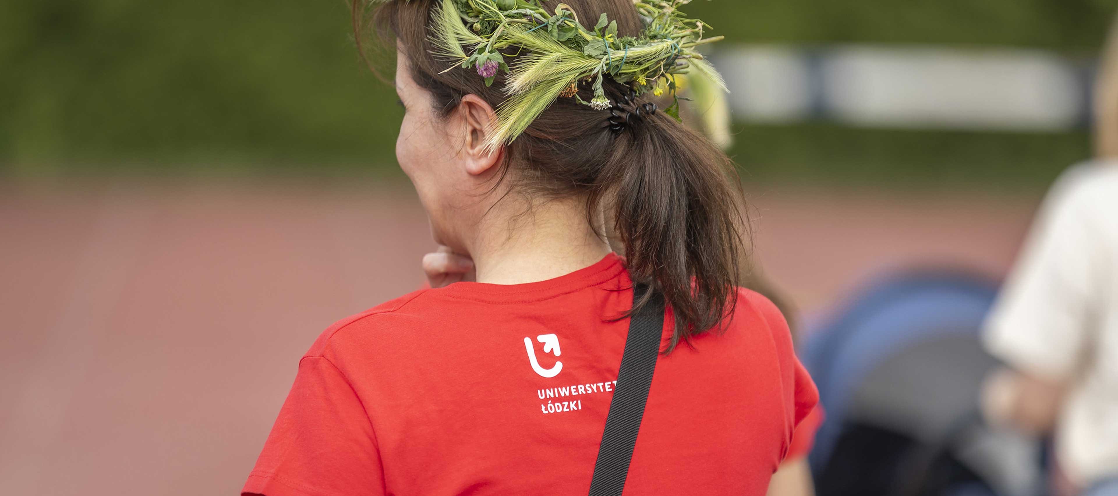 a decorative element: a woman in a wreath wearing a UniLodz T-shirt
