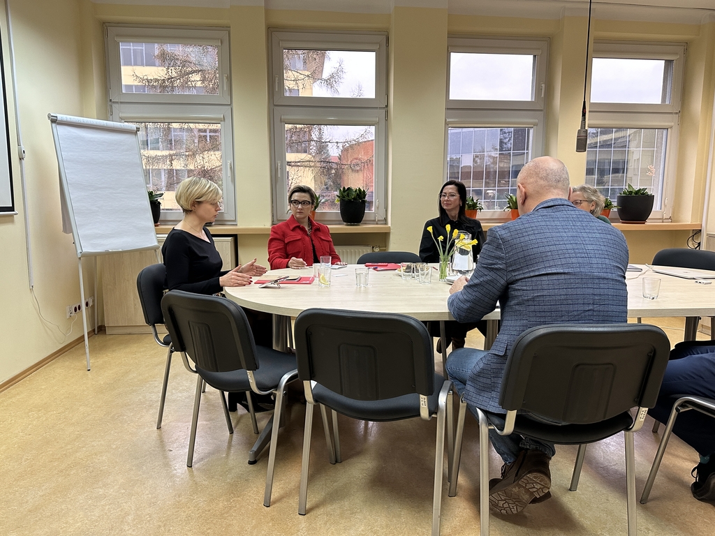 a group of people sitting at a round table